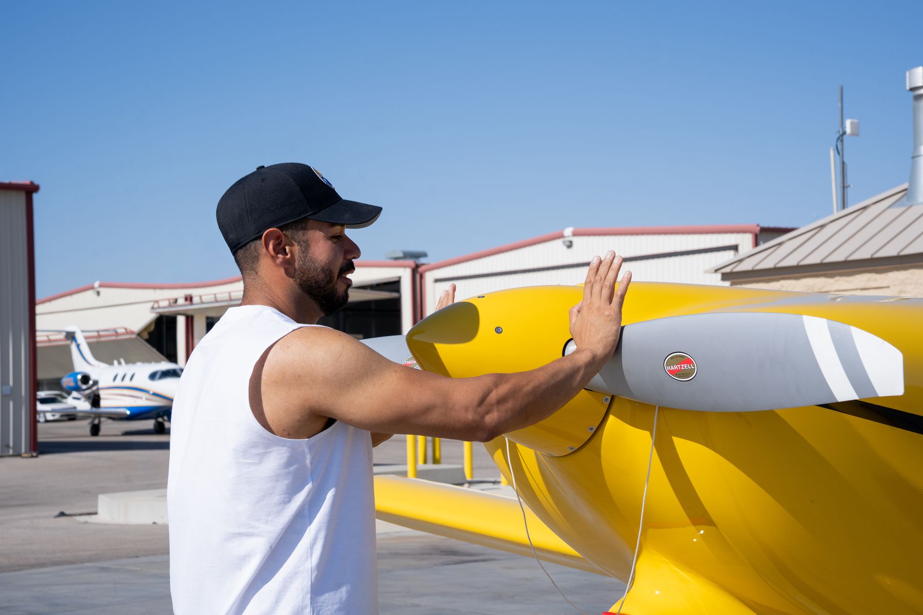 Oscar detailing a yellow prop plane